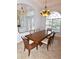 Elegant dining room with tray ceiling, a large window, a chandelier, and marble flooring at 3787 Whippoorwill Ct, Punta Gorda, FL 33950