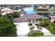 Stunning waterfront home featuring a circular driveway, a three-car garage, and lush landscaping at 3787 Whippoorwill Ct, Punta Gorda, FL 33950