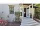 Exterior steps leading to the door, surrounded by tropical plants and flowers at 3787 Whippoorwill Ct, Punta Gorda, FL 33950
