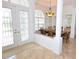 Bright foyer featuring marble floors, double-glass doors, a chandelier, and an archway to the dining room at 3787 Whippoorwill Ct, Punta Gorda, FL 33950