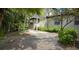 Beautiful brick walkway leading to home surrounded by lush, tropical landscaping at 3787 Whippoorwill Ct, Punta Gorda, FL 33950