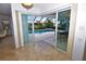 Bright living room featuring marble floors and glass doors leading to a pool and outdoor living space at 3787 Whippoorwill Ct, Punta Gorda, FL 33950