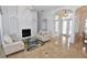 Comfortable living room with a fireplace, high ceilings, marble floors, and neutral furniture at 3787 Whippoorwill Ct, Punta Gorda, FL 33950