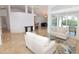 Open-concept living room with marble floors, high ceilings, sliding glass doors to the pool, and neutral decor at 3787 Whippoorwill Ct, Punta Gorda, FL 33950