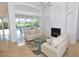 Bright living room featuring a fireplace, sliding glass doors to the pool, and comfortable seating at 3787 Whippoorwill Ct, Punta Gorda, FL 33950