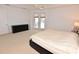 Spacious main bedroom featuring plush carpeting, a ceiling fan, and access to the outdoor patio at 3787 Whippoorwill Ct, Punta Gorda, FL 33950