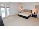 Spacious main bedroom with neutral carpet, ceiling fan, and French doors leading to the pool area at 3787 Whippoorwill Ct, Punta Gorda, FL 33950