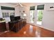 This bright office features french doors, a large desk, and natural light at 3787 Whippoorwill Ct, Punta Gorda, FL 33950