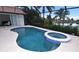 Inviting in-ground pool featuring a connected hot tub, and a screened enclosure with an expansive view at 3787 Whippoorwill Ct, Punta Gorda, FL 33950