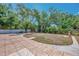 Backyard featuring a grassy area, tiled patio, and perimeter greenery at 4129 Palisades Ave, North Port, FL 34287
