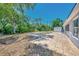 A fully fenced backyard with mature trees offers a shed, tiled patio, and room to roam at 4129 Palisades Ave, North Port, FL 34287