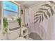 Bathroom featuring a toilet with decor above, and shower with a leafy pattern curtain at 4129 Palisades Ave, North Port, FL 34287