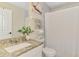 Bright bathroom featuring a granite countertop vanity, white cabinets, and shower with curtain at 4129 Palisades Ave, North Port, FL 34287
