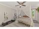 Cozy bedroom featuring a unique canopy bed, ceiling fan, and natural light from the windows at 4129 Palisades Ave, North Port, FL 34287