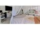 Bright and modern bedroom with a canopy bed, desk, and decor that make for an inspiring space at 4129 Palisades Ave, North Port, FL 34287