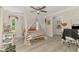 Bright bedroom with a decorative canopy bed, light wood floors and plenty of natural light at 4129 Palisades Ave, North Port, FL 34287