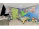 Bedroom featuring light wood floors, ceiling fan, and colorfully painted walls at 4129 Palisades Ave, North Port, FL 34287