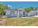 Charming single-story home featuring a well-manicured lawn and two-car garage at 4129 Palisades Ave, North Port, FL 34287