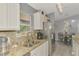 Kitchen featuring stainless steel appliances and granite countertops plus a view into the dining area at 4129 Palisades Ave, North Port, FL 34287