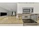 Kitchen area featuring an electric range and granite countertops plus a view to the living area at 4129 Palisades Ave, North Port, FL 34287