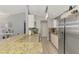 Spacious kitchen with modern appliances, granite countertops, and bar seating area, bathed in natural light at 4129 Palisades Ave, North Port, FL 34287