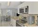 Bright kitchen featuring granite countertops, stainless steel appliances, and a view to the dining area at 4129 Palisades Ave, North Port, FL 34287
