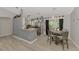 Open-concept kitchen with stainless steel appliances, granite countertops, a breakfast bar, and views to the dining area at 4129 Palisades Ave, North Port, FL 34287