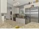 Bright kitchen with stainless steel appliances, granite countertops, and ample cabinet space for storage at 4129 Palisades Ave, North Port, FL 34287