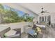 The screened lanai shows peaceful views of the lush backyard and nearby seating at 4129 Palisades Ave, North Port, FL 34287