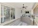 Covered lanai showing outdoor seating and open view into the home's interior at 4129 Palisades Ave, North Port, FL 34287