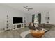 Bright and spacious living room with a large sectional sofa, modern entertainment center, and stylish decor at 4129 Palisades Ave, North Port, FL 34287