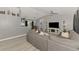 Spacious open-concept living room with a large sofa, entertainment center, and access to the kitchen at 4129 Palisades Ave, North Port, FL 34287