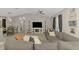 Comfortable living room with a large gray sectional, vaulted ceiling, and view of the dining area at 4129 Palisades Ave, North Port, FL 34287