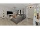 Inviting living room with modern decor, a large sectional sofa, and ample natural light from the windows at 4129 Palisades Ave, North Port, FL 34287