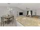 Open concept living and dining area with granite countertops and modern furnishings creates an inviting space at 4129 Palisades Ave, North Port, FL 34287