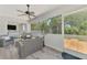 Screened patio area with comfortable gray patio furniture and ceiling fan at 4129 Palisades Ave, North Port, FL 34287