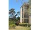 Three story condo with balcony, beautiful landscaping, and fire hydrant at 618 Bird Bay S Dr # 109, Venice, FL 34285