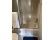 Bright bathroom showcases a tub and shower combo with framed sliding door access and blue bathmat at 618 Bird Bay S Dr # 109, Venice, FL 34285
