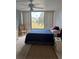 Bright bedroom with a large window offering views of the garden and a comfortable bed at 618 Bird Bay S Dr # 109, Venice, FL 34285