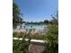 Community pool surrounded by sun loungers, manicured gardens, and a privacy fence at 618 Bird Bay S Dr # 109, Venice, FL 34285