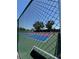 View of the community tennis court with vibrant colors, creating a fun and social environment at 618 Bird Bay S Dr # 109, Venice, FL 34285