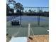 Community tennis court surrounded by fencing and foliage, offering an active lifestyle at 618 Bird Bay S Dr # 109, Venice, FL 34285