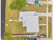 Aerial view of a single-Gathering home with a spacious yard, boat dock, patio area, and private driveway at 6309 Pontiac Ln, North Port, FL 34287