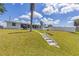 View of backyard with grassy area, concrete stairs, and canal at 6309 Pontiac Ln, North Port, FL 34287
