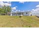 Lawn with a glimpse of screened-in porch in a well maintained backyard at 6309 Pontiac Ln, North Port, FL 34287