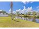 Lush backyard with green grass leading to a canal offering serene water views and a peaceful setting at 6309 Pontiac Ln, North Port, FL 34287