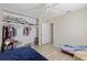 Comfortable bedroom featuring built-in closet with shelves and well-lit doorway at 6309 Pontiac Ln, North Port, FL 34287