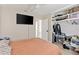 Bedroom with a ceiling fan, a TV, and a closet with built-in shelving at 6309 Pontiac Ln, North Port, FL 34287