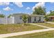 Inviting single-story home with a well-kept front yard and modern gray exterior paint at 6309 Pontiac Ln, North Port, FL 34287
