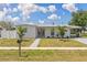 Attractive single-story home featuring a pristine lawn, covered parking and freshly painted exterior at 6309 Pontiac Ln, North Port, FL 34287